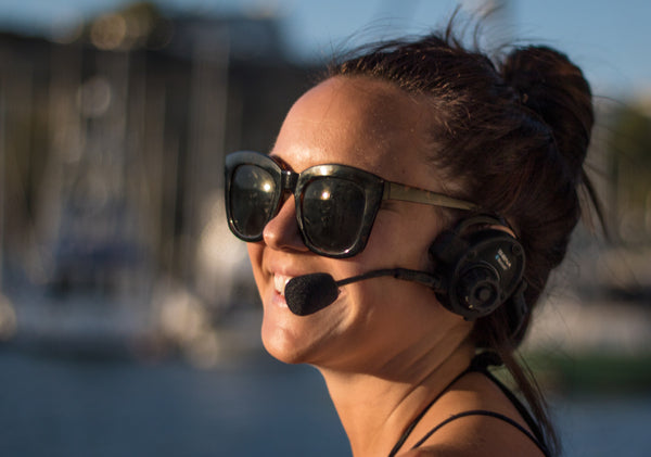 Man wearing Sena SPH10 headset at a marina or port with boats in background - imagen 10