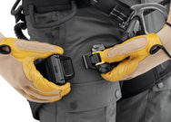 Arborist with gloves fastening the FAST buckle on a Petzl SEQUOIA harness leg loop - imagen 4