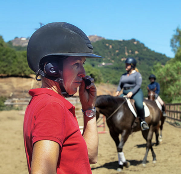 Rider wearing Sena EXPAND Mesh headset on horseback in outdoor landscape - imagen 5