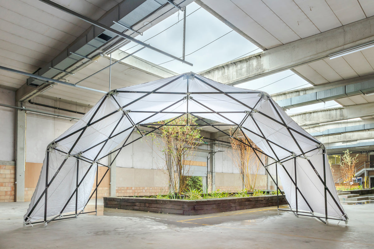 Konligo Fastival structure with white membrane cover set up indoors around a central planter, now available on MTN Shop US. - imagen 7