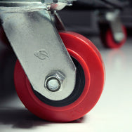 Close-up of a red wheel with metal axle on a blurred background  - imagen 4